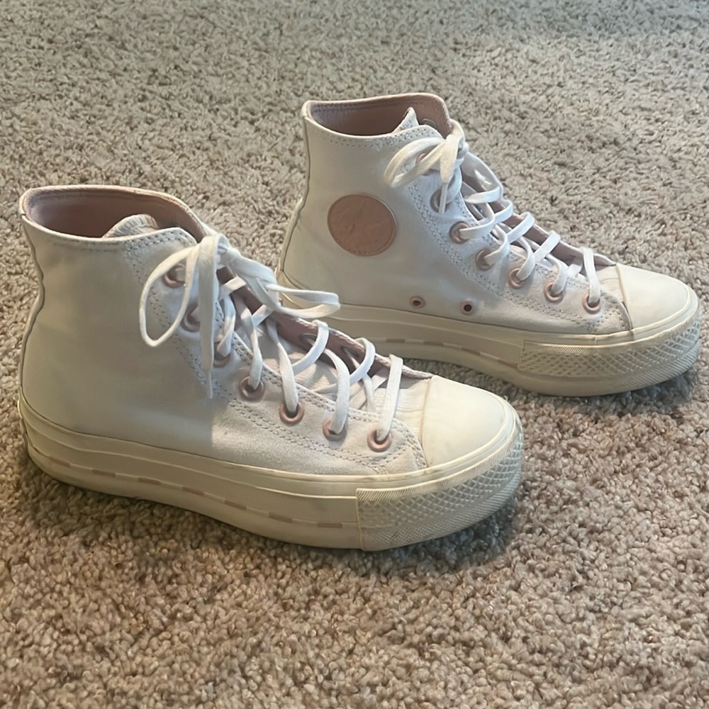 White with light pink high top/platform converse.